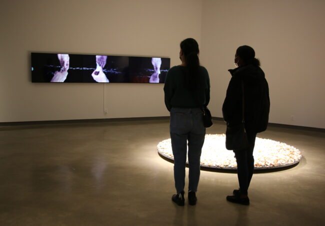 2 people viewing art in the gallery.